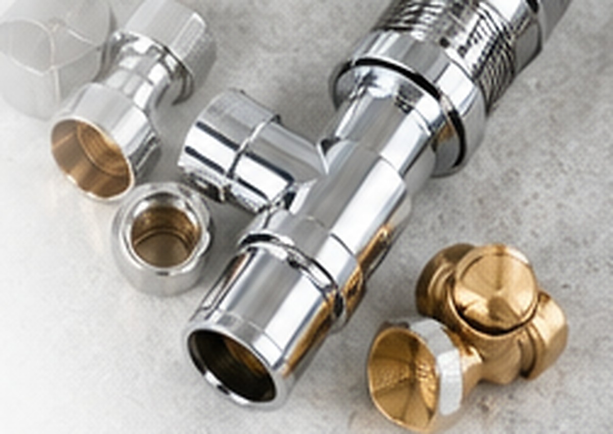 Professional plumbing fittings and connectors presented as product photography